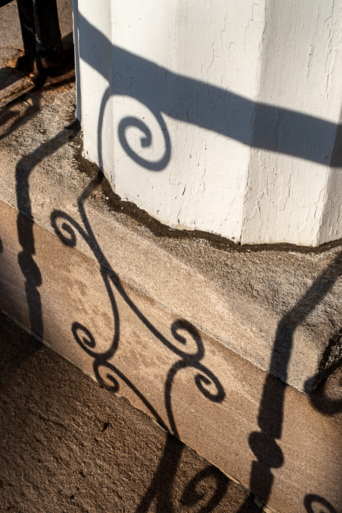 Railing shadow on steps and column