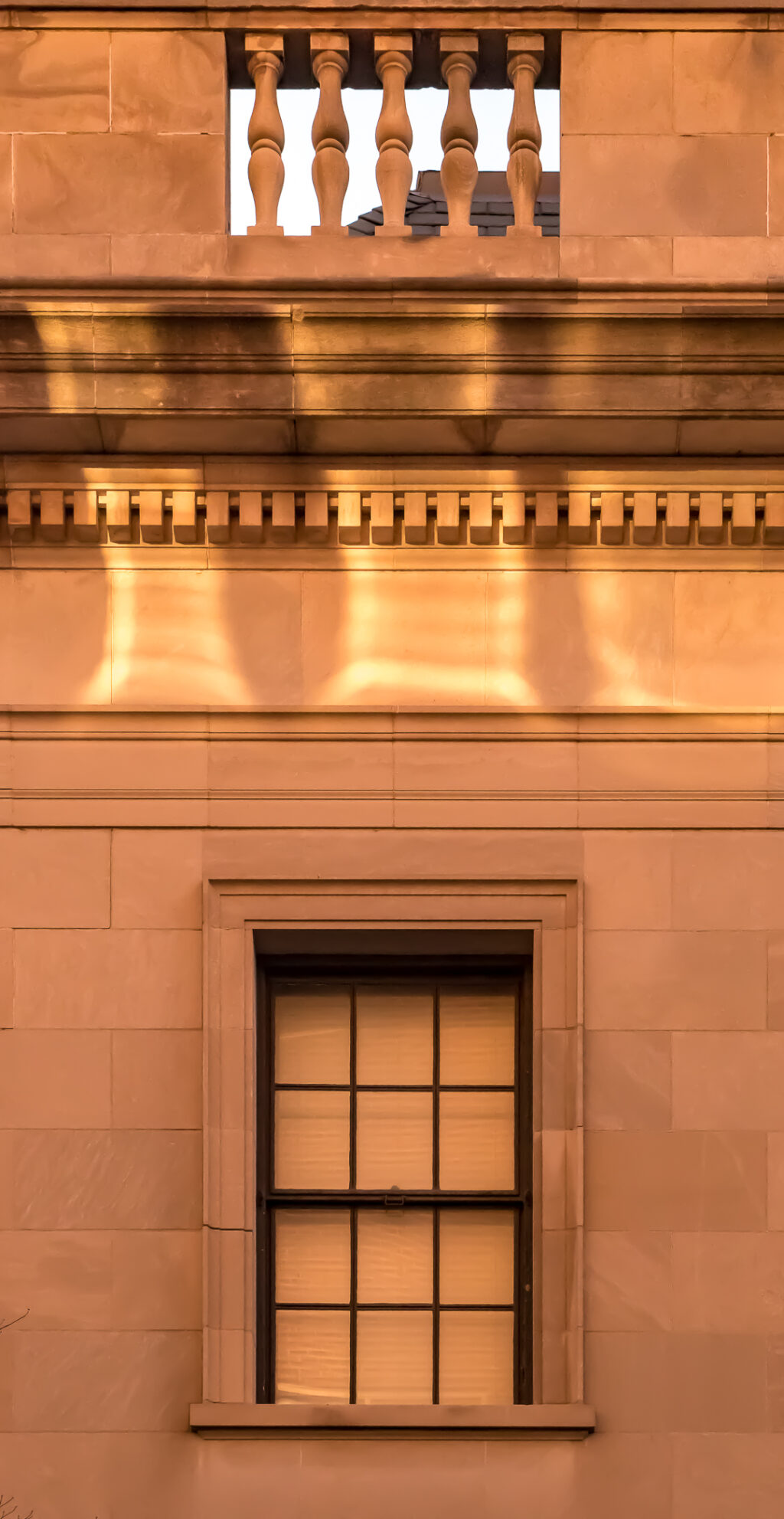 Wall with sun reflections and a window