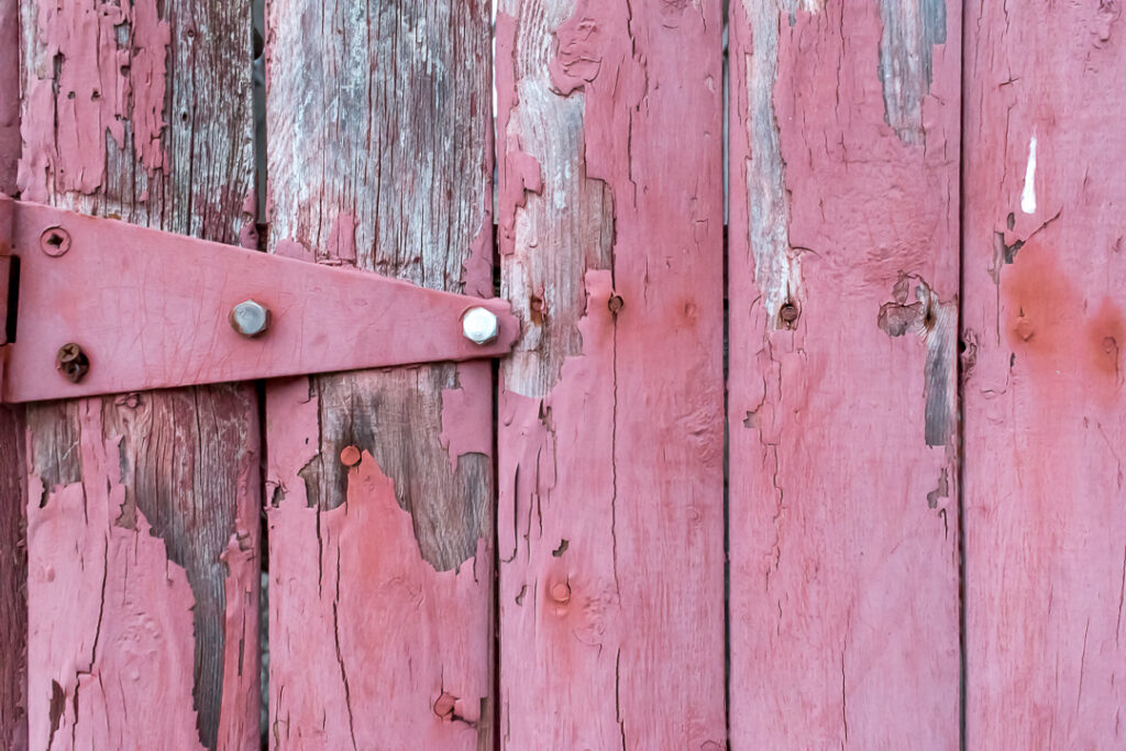 A red fence with peeling paint